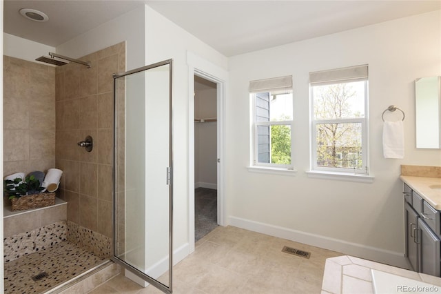 10109 E 28th Ave, Denver, CO 80238 - full bath featuring a stall shower, vanity, baseboards, tile patterned flooring, and a spacious closet