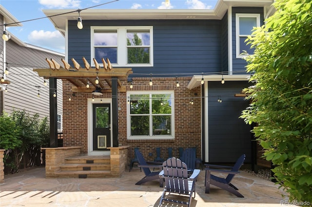 10109 E 28th Ave, Denver, CO 80238 - rear view of house featuring brick siding, a patio area, and a pergola