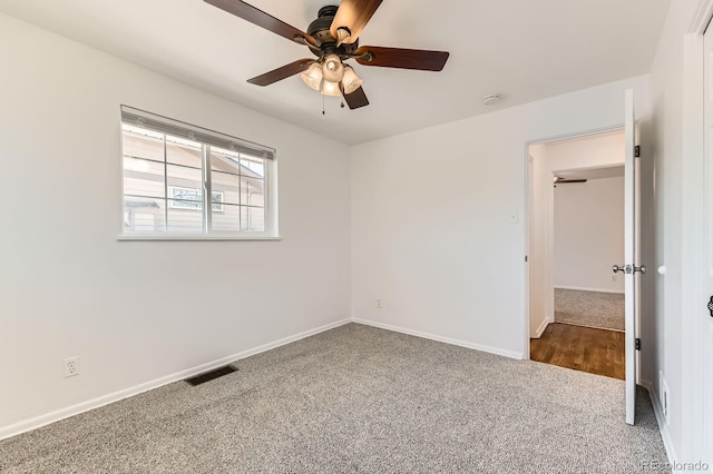 unfurnished bedroom featuring visible vents, baseboards, a ceiling fan, and carpet floors