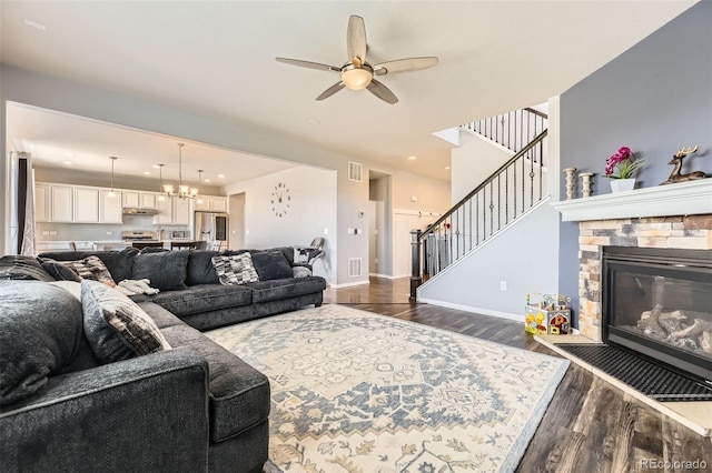 7360 S Old Hammer Way, Aurora, CO 80016 - living area with ceiling fan, dark wood-style flooring, stairway, a chandelier, and a fireplace