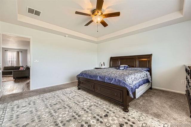 7360 S Old Hammer Way, Aurora, CO 80016 - bedroom featuring a raised ceiling, light colored carpet, and ceiling fan