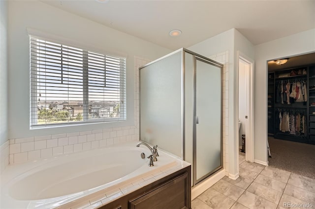 7360 S Old Hammer Way, Aurora, CO 80016 - bathroom featuring a bath, a shower stall, a spacious closet, and tile patterned floors