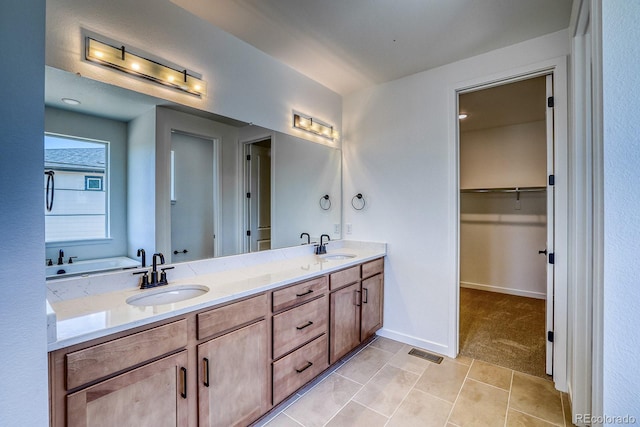 23738 E 42nd Ave, Aurora, CO 80019 - full bath featuring double vanity, a spacious closet, and tile patterned floors