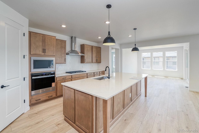 23738 E 42nd Ave, Aurora, CO 80019 - kitchen featuring stainless steel appliances, wall chimney exhaust hood, light wood-type flooring, decorative backsplash, and recessed lighting