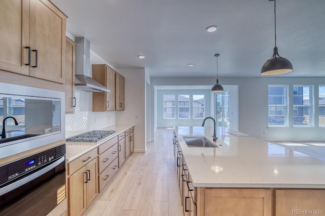 23738 E 42nd Ave, Aurora, CO 80019 - kitchen featuring wall chimney range hood, stainless steel gas cooktop, oven, plenty of natural light, and recessed lighting
