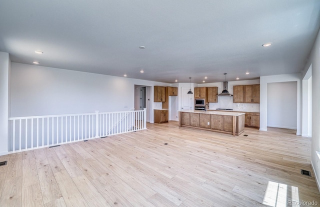 23738 E 42nd Ave, Aurora, CO 80019 - unfurnished living room with recessed lighting and light wood-style flooring