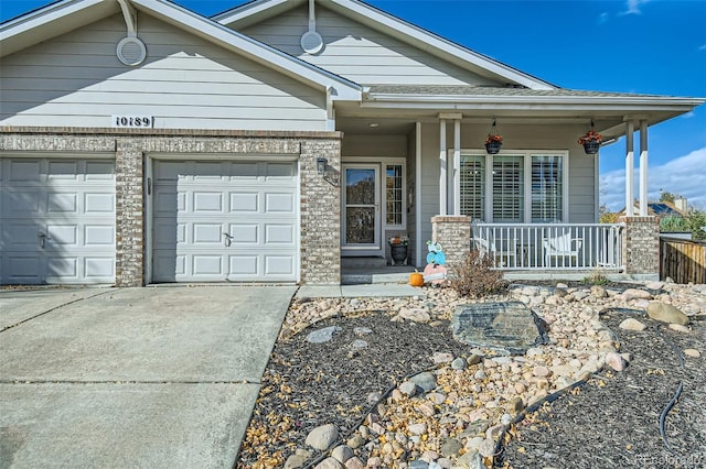 view of front of home featuring covered porch and a garage