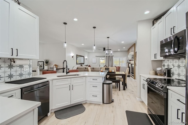 kitchen featuring white cabinetry, decorative backsplash, sink, and appliances with stainless steel finishes