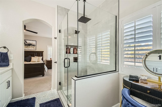 bathroom with ceiling fan, vanity, and an enclosed shower