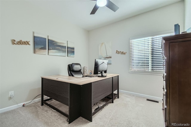 carpeted home office with ceiling fan