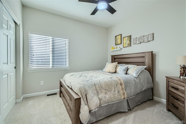 bedroom featuring a closet, ceiling fan, and light colored carpet