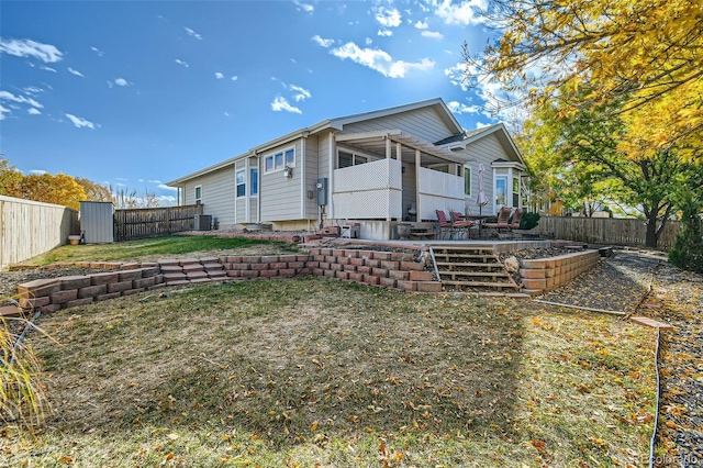 back of property featuring a patio area, central AC unit, and a storage shed