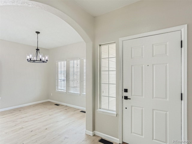 entrance foyer featuring a chandelier and light wood-type flooring