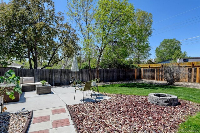 10769 Carrol Ln, Northglenn, CO 80233 - view of yard with a patio area and an outdoor living space with a fire pit