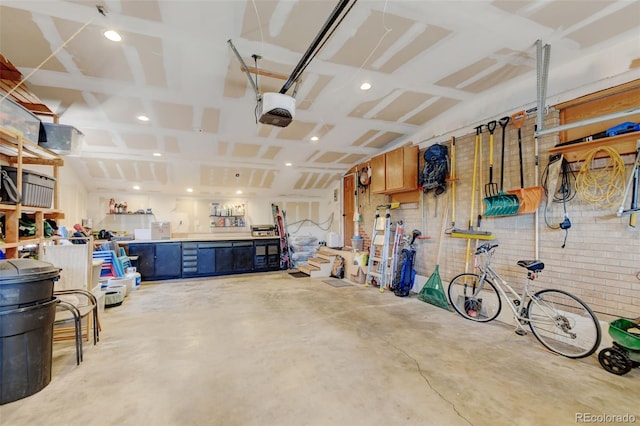 10769 Carrol Ln, Northglenn, CO 80233 - garage featuring a garage door opener, a workshop area, and recessed lighting