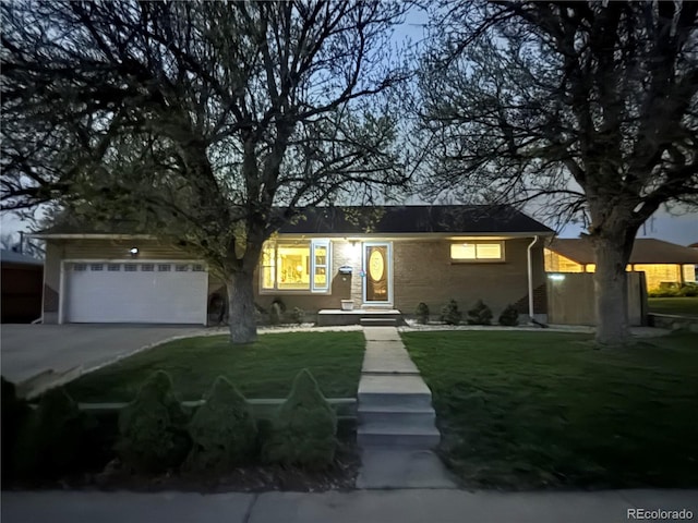 10769 Carrol Ln, Northglenn, CO 80233 - ranch-style house with driveway, a front lawn, an attached garage, and brick siding
