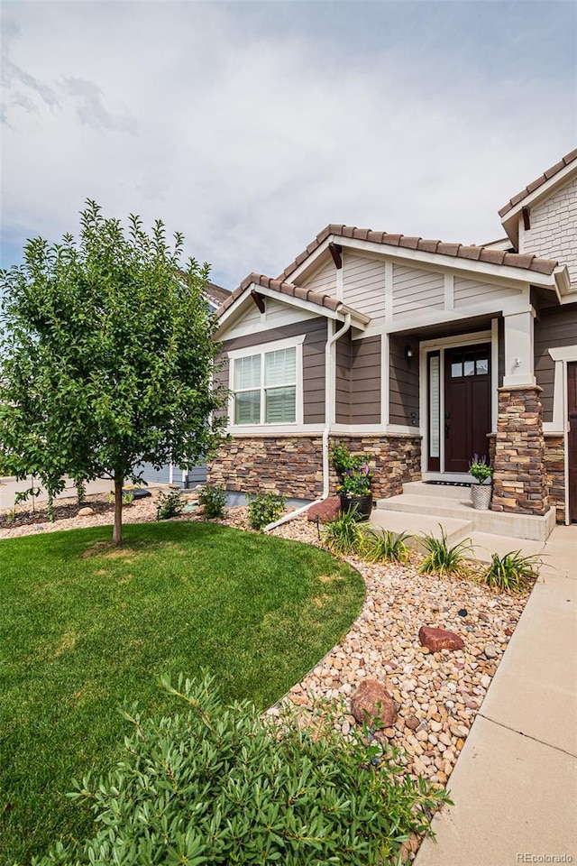 10272 Greenfield Cir, Parker, CO 80134 - view of front of property with a front yard, a tile roof, and stone siding