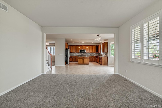10272 Greenfield Cir, Parker, CO 80134 - unfurnished living room featuring stairway, light tile patterned floors, light carpet, baseboards, and recessed lighting