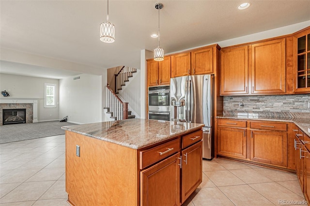 10272 Greenfield Cir, Parker, CO 80134 - kitchen featuring appliances with stainless steel finishes, light tile patterned floors, brown cabinets, light stone countertops, and recessed lighting