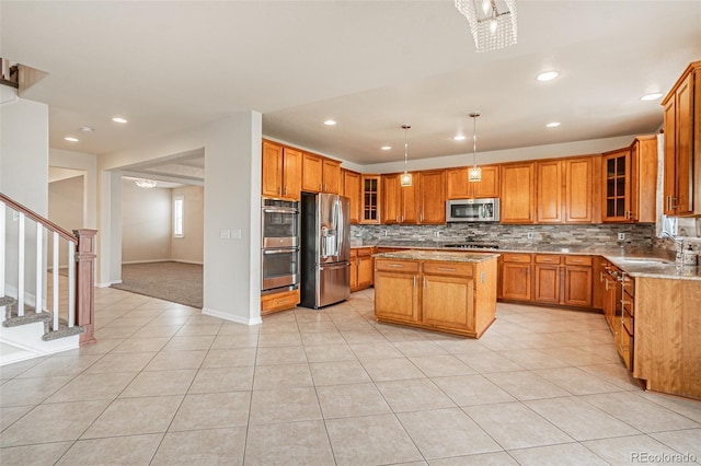 10272 Greenfield Cir, Parker, CO 80134 - kitchen with stainless steel appliances, brown cabinetry, a sink, backsplash, and a kitchen island
