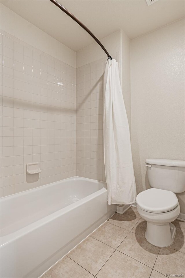 10272 Greenfield Cir, Parker, CO 80134 - full bath featuring toilet, tile patterned flooring, and shower / tub combo with curtain