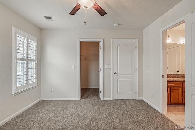 10272 Greenfield Cir, Parker, CO 80134 - unfurnished bedroom with a walk in closet, light carpet, a closet, and baseboards