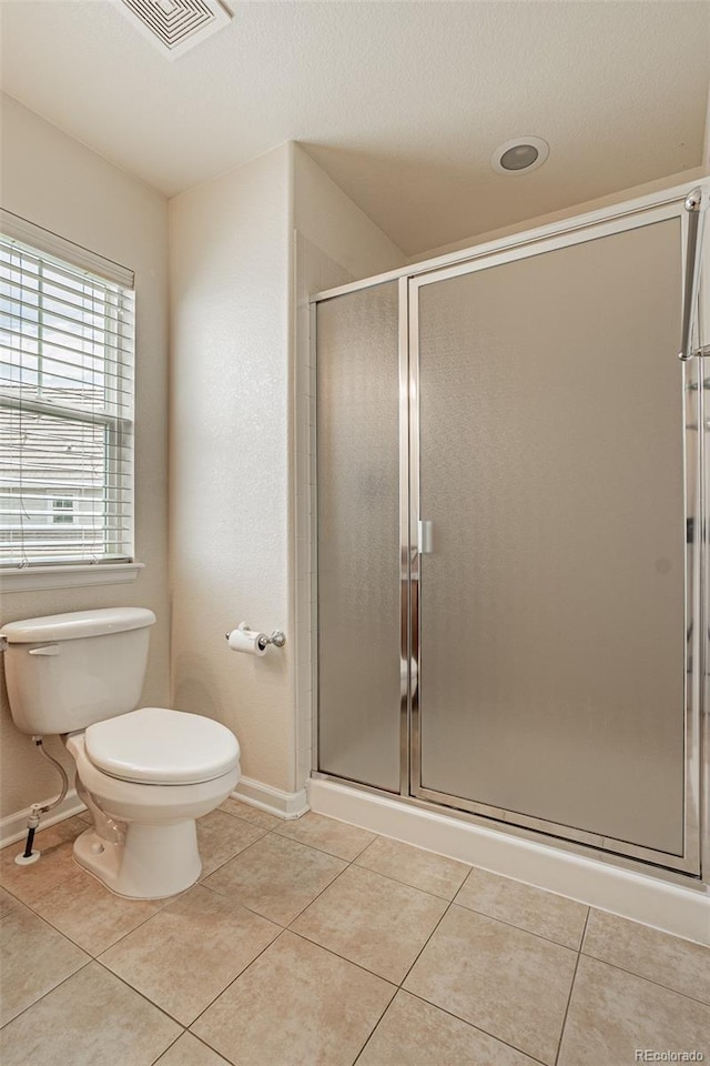 10272 Greenfield Cir, Parker, CO 80134 - full bath featuring toilet, a shower stall, baseboards, and tile patterned flooring