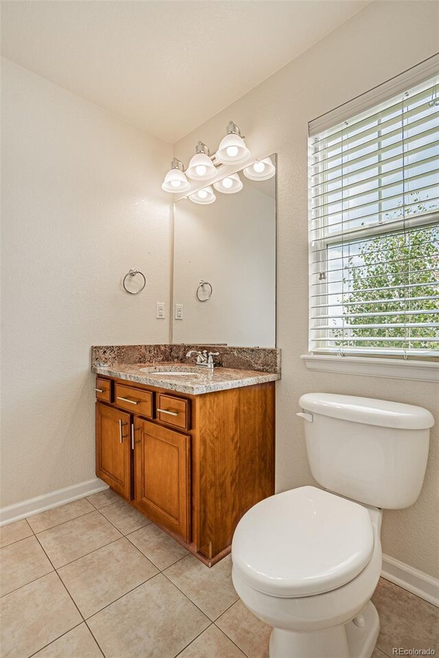 10272 Greenfield Cir, Parker, CO 80134 - half bathroom with vanity, toilet, and tile patterned flooring