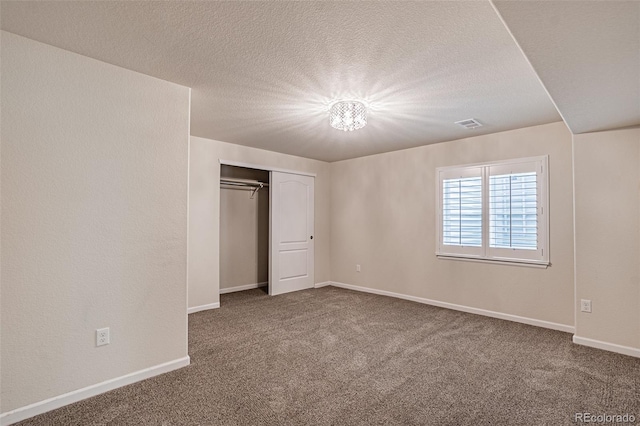 10272 Greenfield Cir, Parker, CO 80134 - unfurnished bedroom featuring carpet flooring, a closet, baseboards, and a textured ceiling