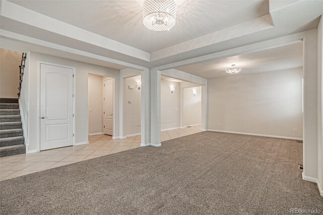 10272 Greenfield Cir, Parker, CO 80134 - basement with carpet floors, a chandelier, tile patterned flooring, stairs, and baseboards