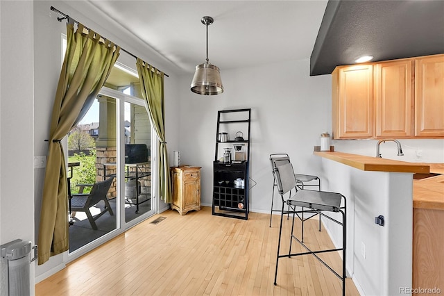 dining space featuring light wood-type flooring and baseboards