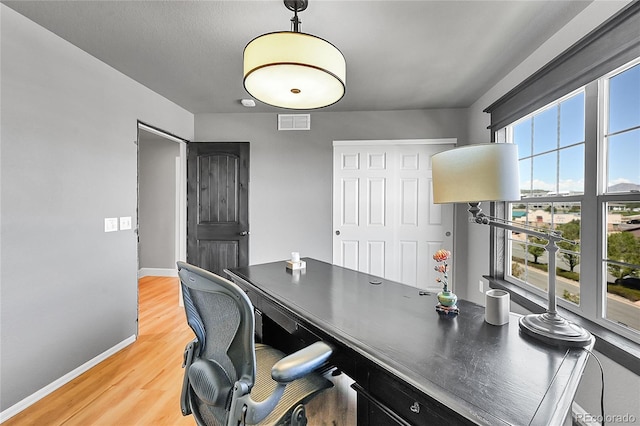 office with baseboards and light wood finished floors