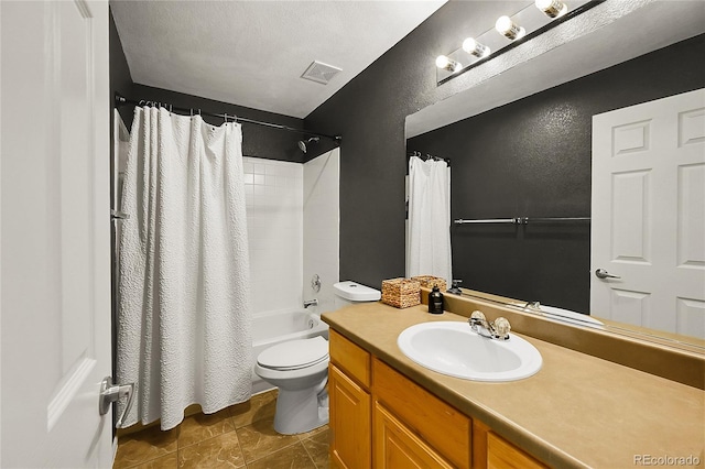 bathroom featuring a textured wall, toilet, vanity, shower / bath combination with curtain, and tile patterned flooring