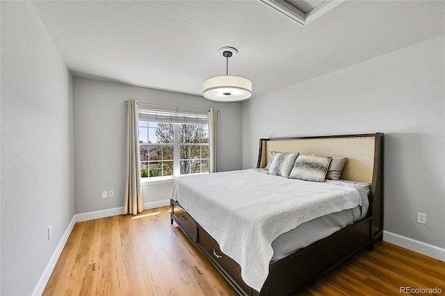 bedroom featuring light wood-style floors and baseboards
