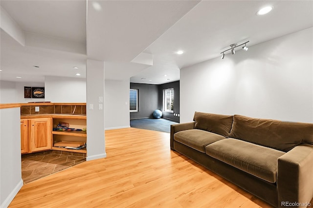 living area with wood finished floors, recessed lighting, and baseboards