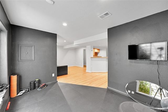 workout area with wood finished floors, baseboards, and recessed lighting