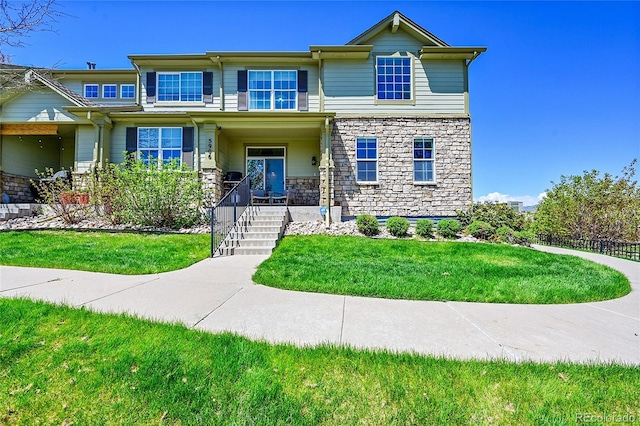 5906 S Youngfield Way, Littleton, CO 80127 - view of front of property featuring stone siding, a front yard, and a porch