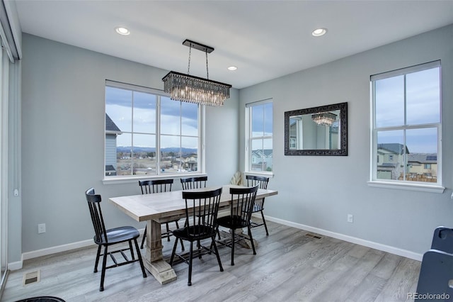 dining room featuring baseboards and light wood finished floors
