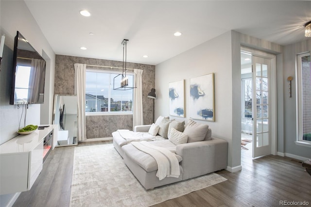 living room featuring a wealth of natural light, wood finished floors, and recessed lighting