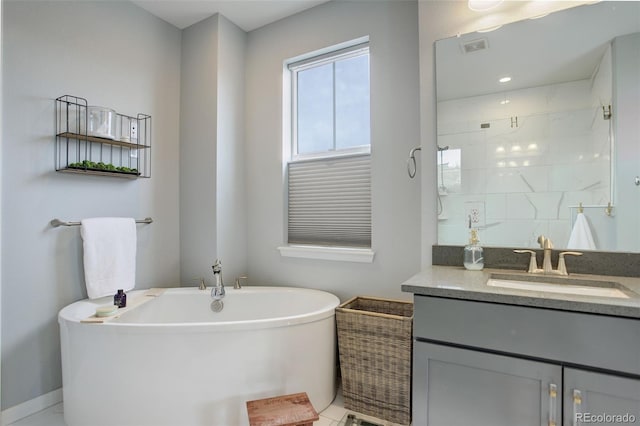 bathroom with vanity, baseboards, a stall shower, visible vents, and a freestanding bath