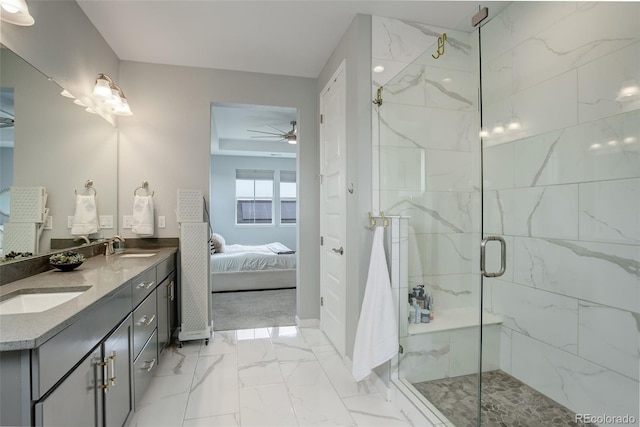 ensuite bathroom featuring a sink, a marble finish shower, a ceiling fan, marble finish floor, and double vanity