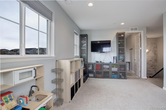 living room with carpet flooring, visible vents, and recessed lighting