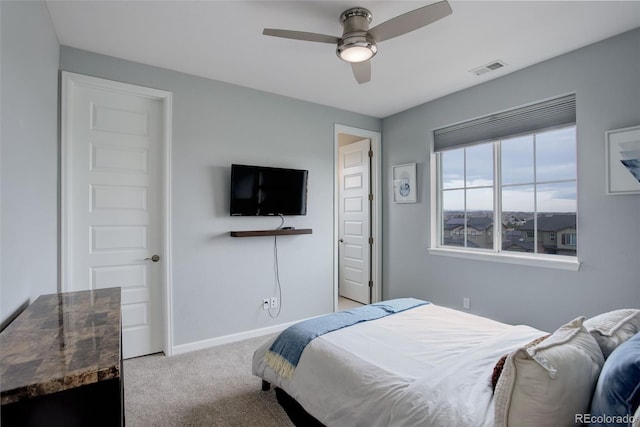carpeted bedroom with baseboards and a ceiling fan