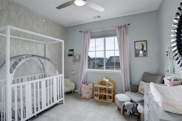 carpeted bedroom with visible vents and a ceiling fan