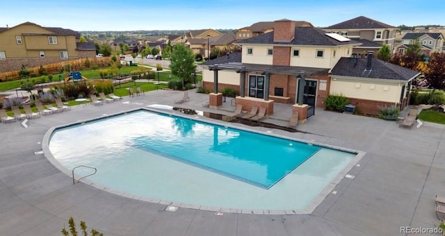 pool with a pergola, a residential view, fence, and a patio