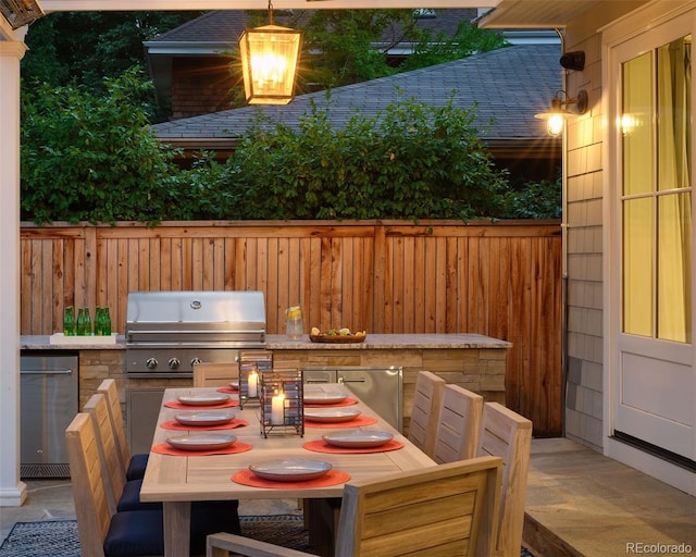 2130 S Milwaukee St, Denver, CO 80210 - view of patio with a grill, exterior kitchen, and fence