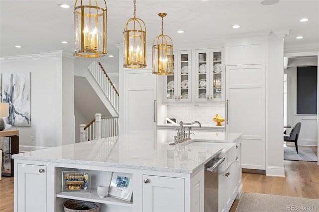 2130 S Milwaukee St, Denver, CO 80210 - kitchen with a center island with sink, light wood finished floors, open shelves, ornamental molding, and white cabinetry