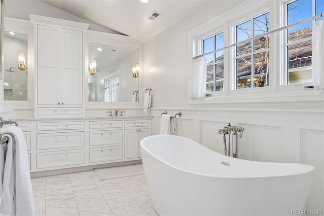 2130 S Milwaukee St, Denver, CO 80210 - full bathroom with vanity, vaulted ceiling, wainscoting, a decorative wall, and marble finish floor
