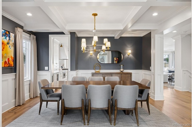 2130 S Milwaukee St, Denver, CO 80210 - dining space featuring beam ceiling, plenty of natural light, coffered ceiling, and an inviting chandelier