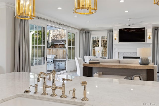 2130 S Milwaukee St, Denver, CO 80210 - dining space featuring ornamental molding, recessed lighting, a fireplace, and a chandelier